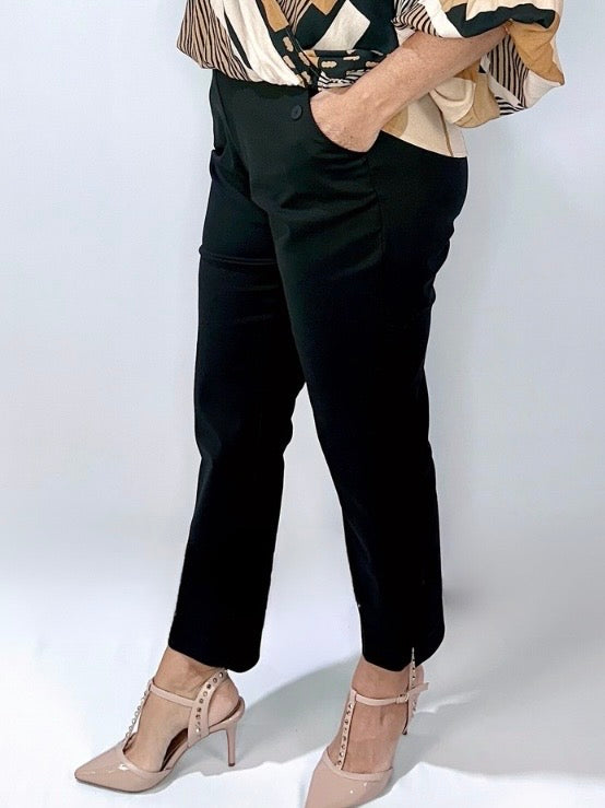 Woman wearing Kerry's Style Sessions high-waisted black pants paired with nude heels and a patterned blouse.