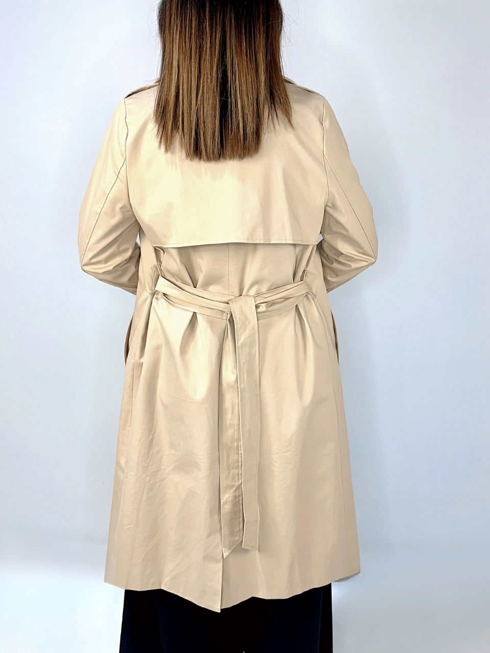 Back view of Kerry's Style Sessions beige trench coat with tie belt and storm flap detail.