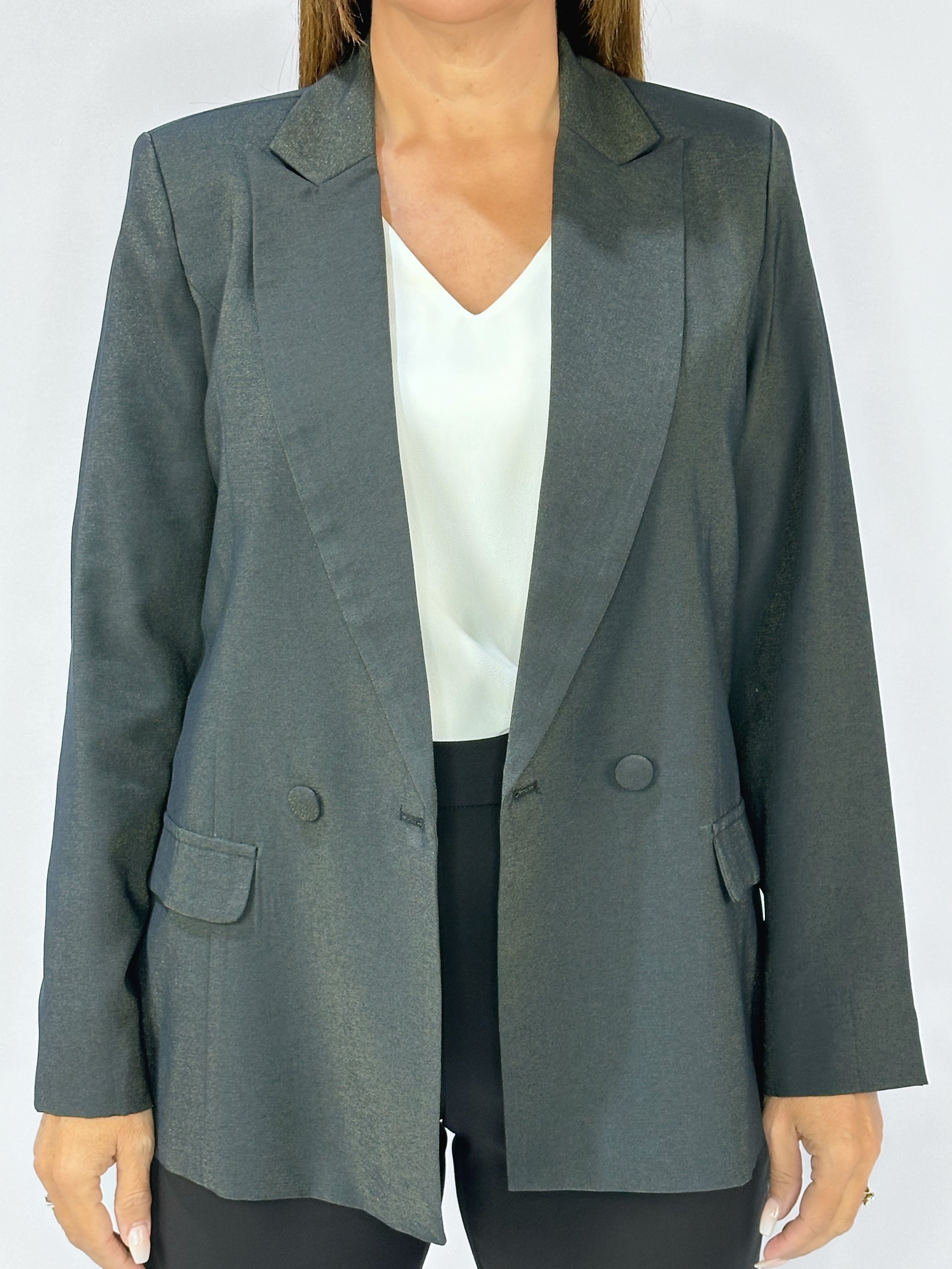 Close-up of Kerry's Style Sessions black tailored blazer with double-breasted button details, worn over a white top.