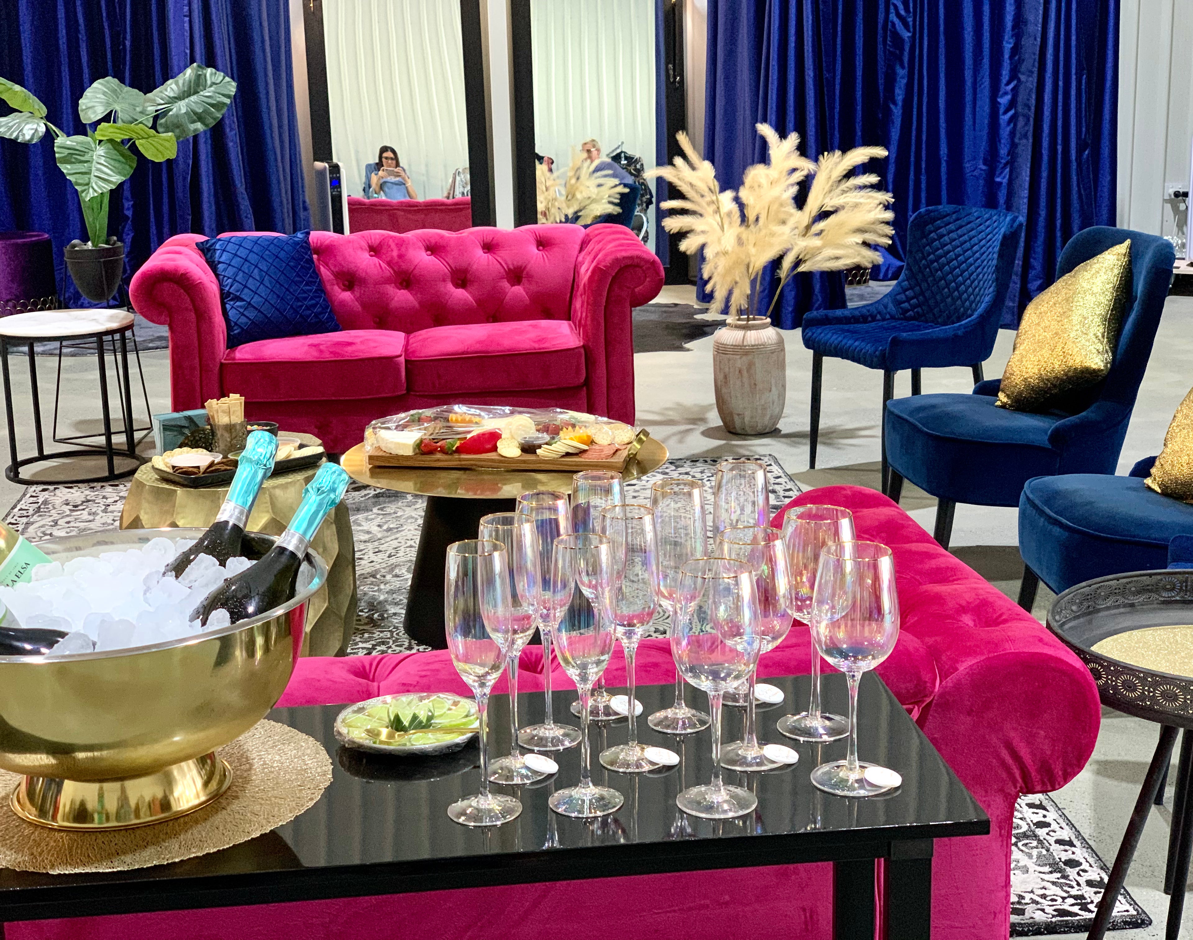 A vibrant, stylish lounge setup with drinks, glassware, and elegant seating, perfect for a chic social event.