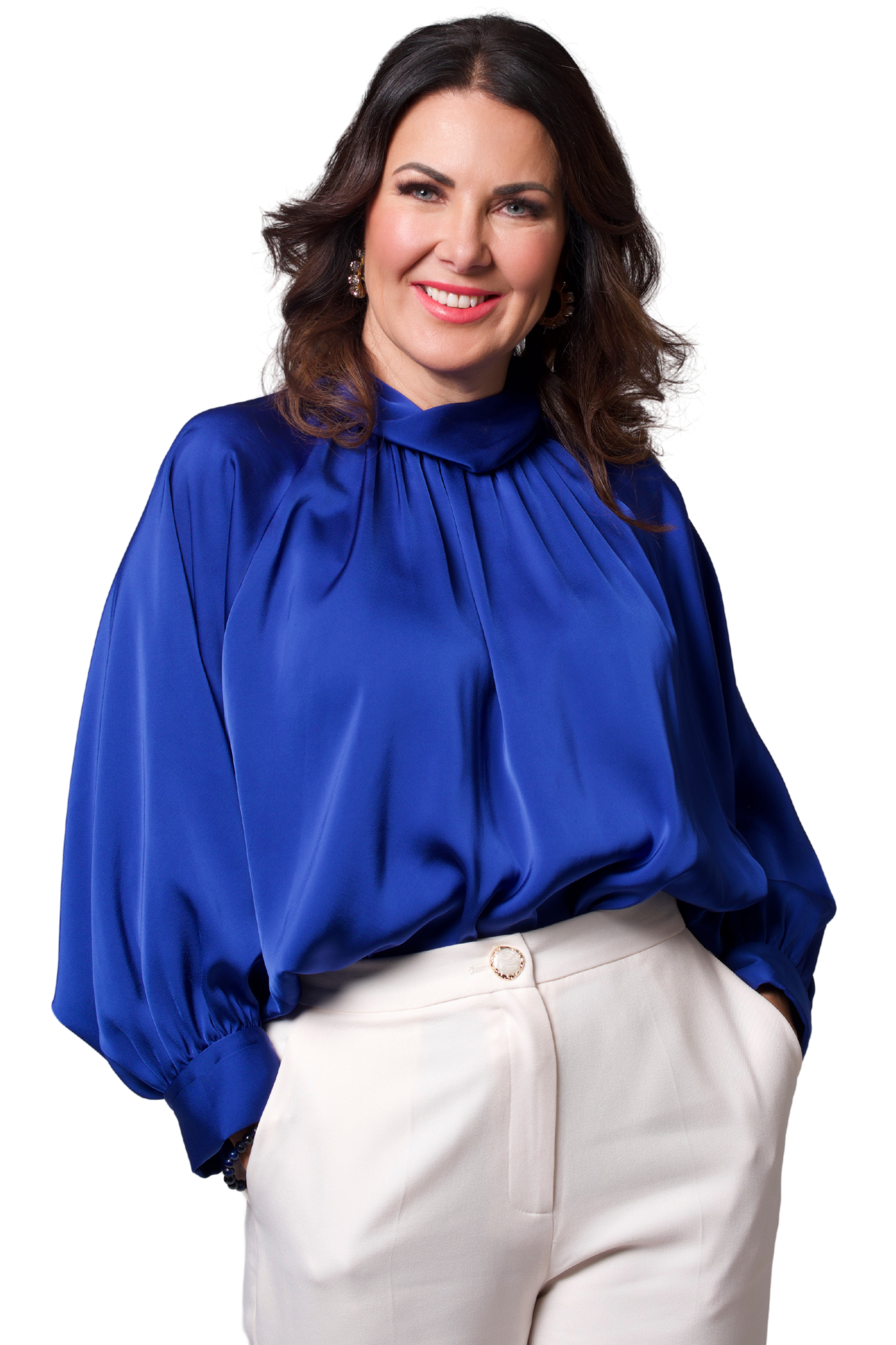 Royal blue blouse with voluminous sleeves tucked into high-waisted white trousers for a chic and sophisticated style.