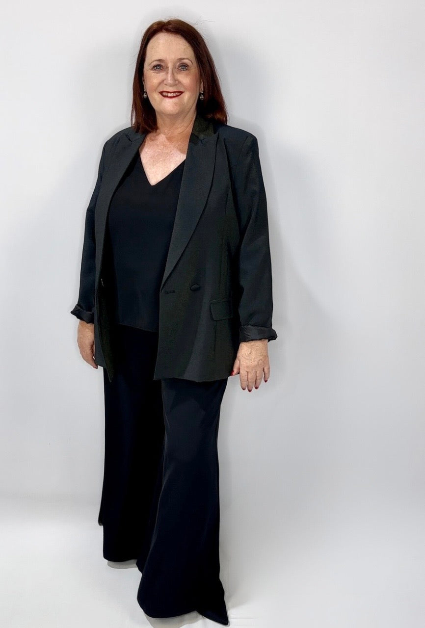 Woman wearing Kerry's Style Sessions black blazer, black V-neck top, and wide-leg black pants.
