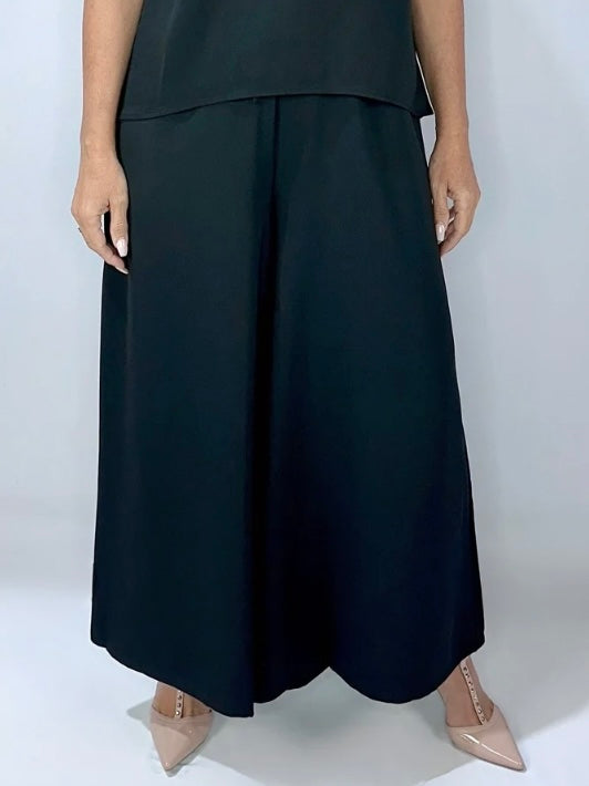 Close-up view of KStyle black wide-leg pants featuring a flowy design, elasticated waist, and relaxed fit, paired with nude heels.