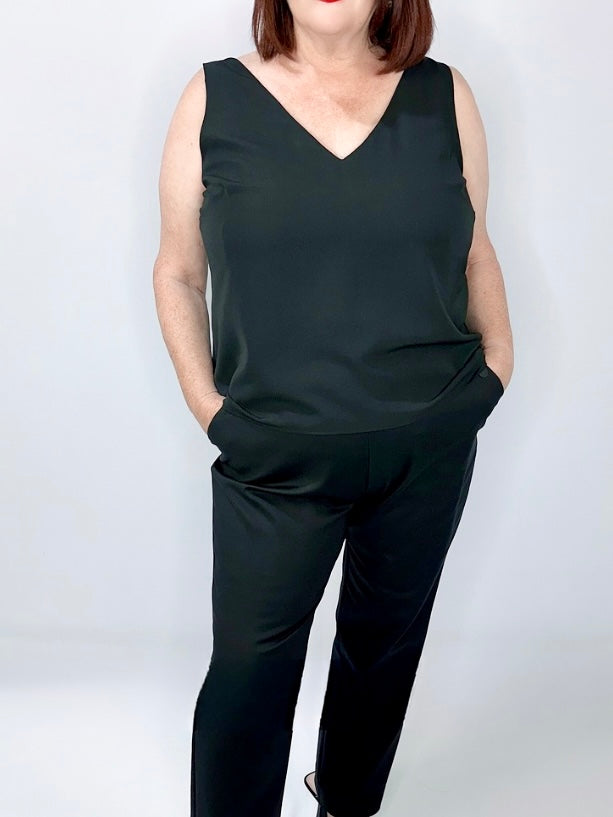 Woman wearing Kerry's Style Sessions black sleeveless V-neck top paired with black pants.