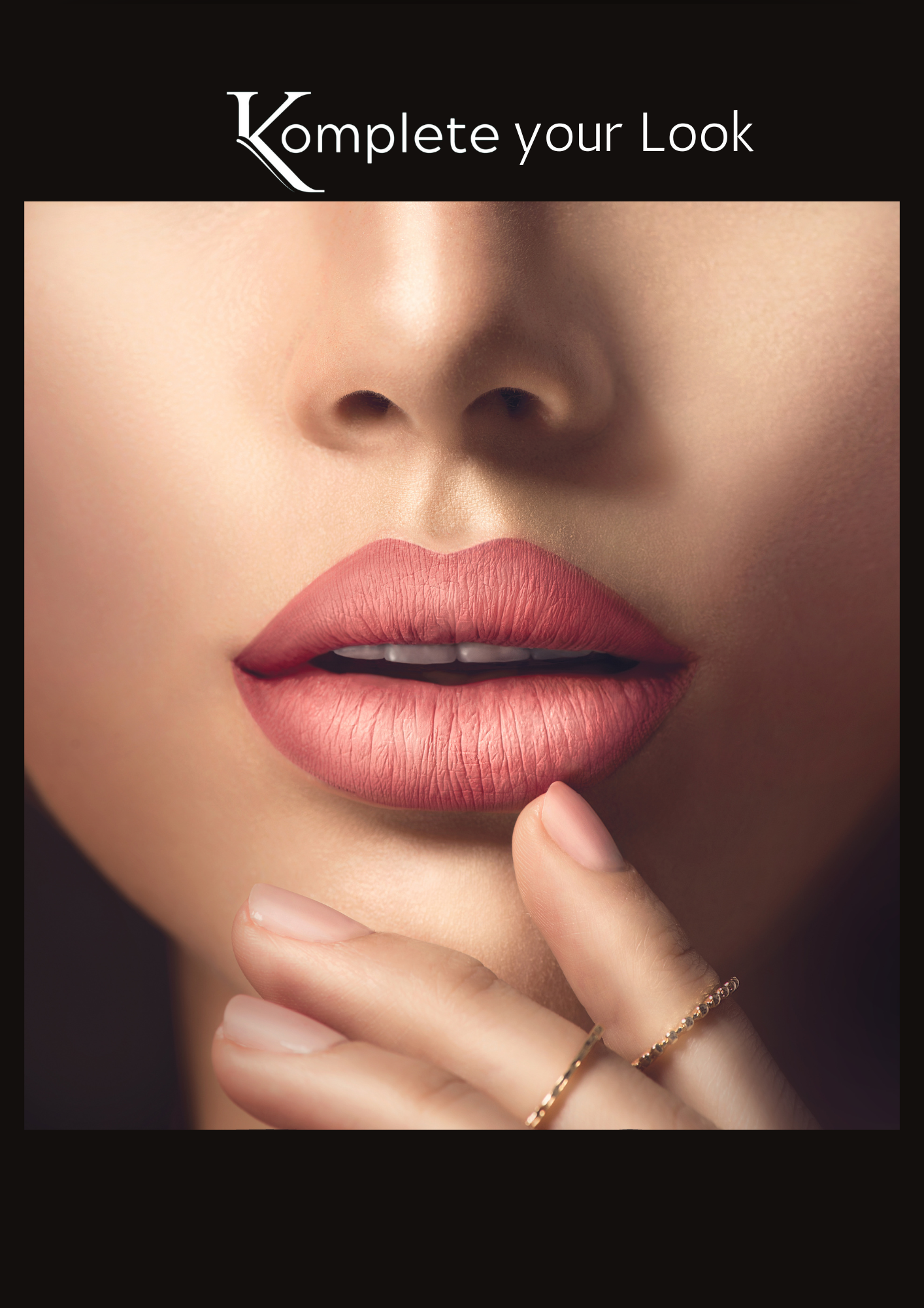 Close-up of lips in a satin pink shade with gold rings on manicured fingers.