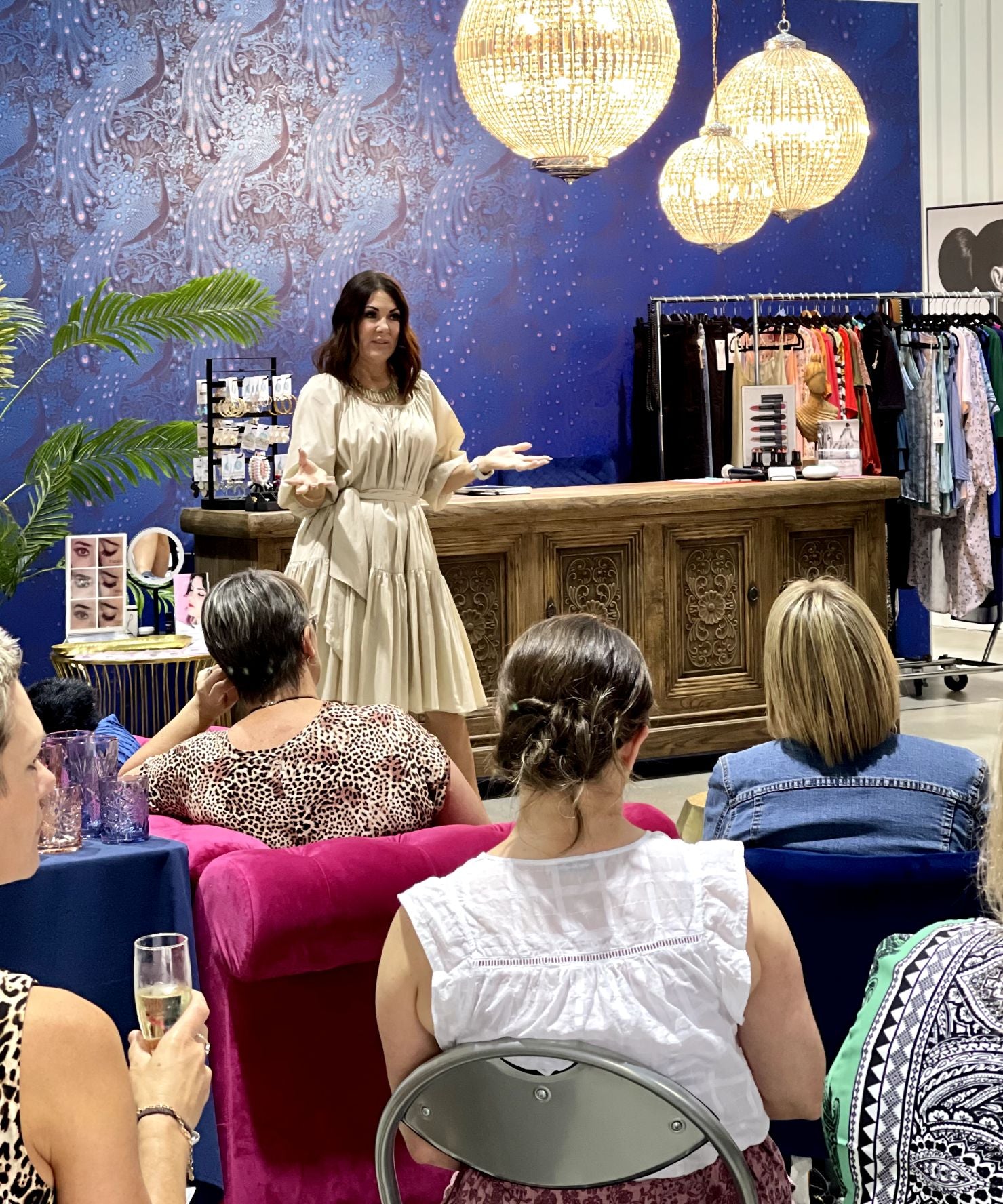 Engaging style session with fashion tips, surrounded by chic décor and attentive participants.